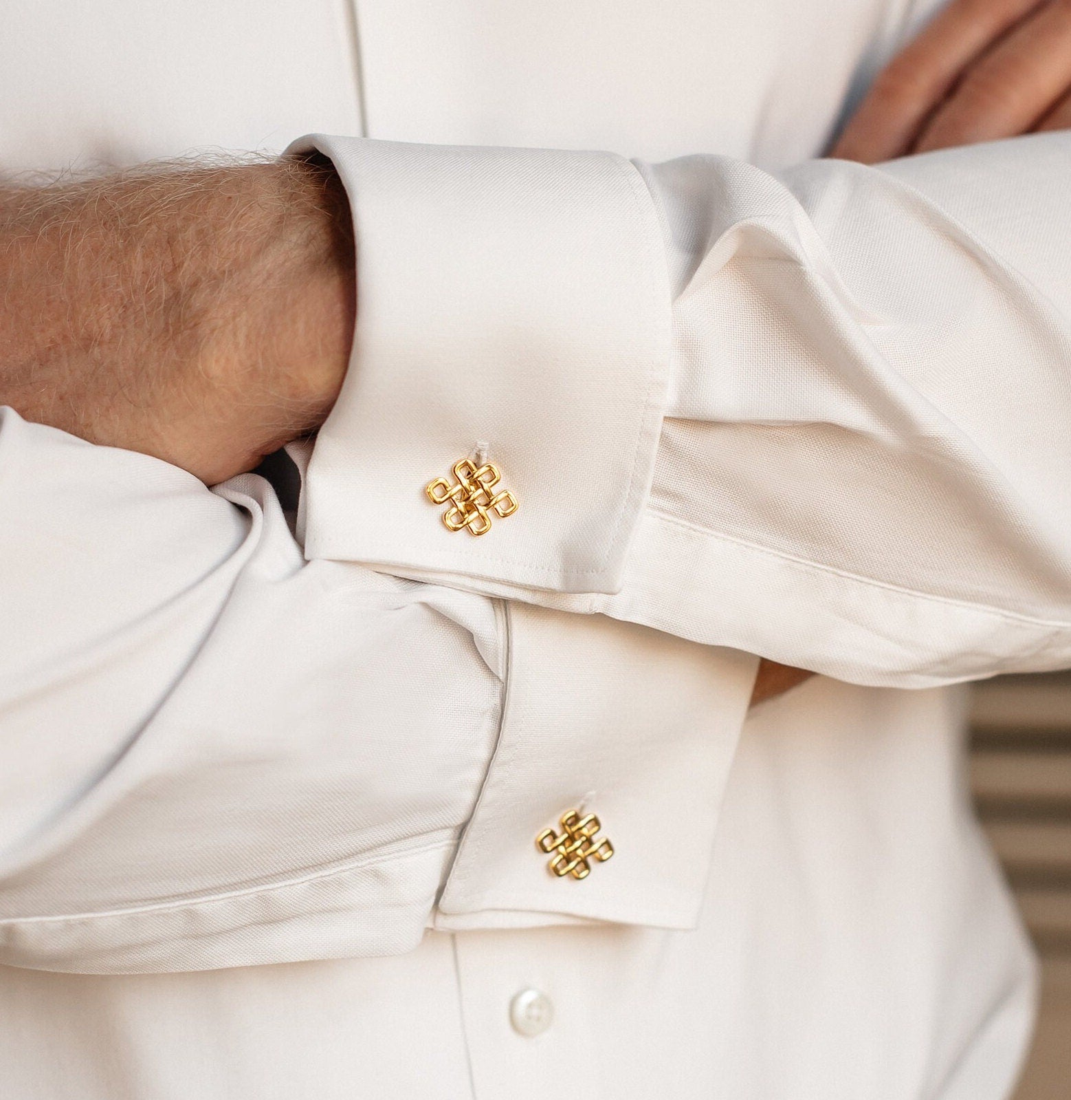 Gold knot cufflinks styled with formal men’s suit